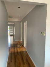 Hallway painted in grey with crisp white door frames and skirting