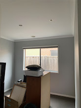 Dining area with grey feature walls and white painted ceiling