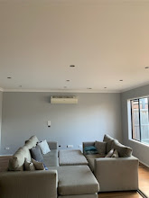 Living room with smooth painted ceiling and soft grey walls